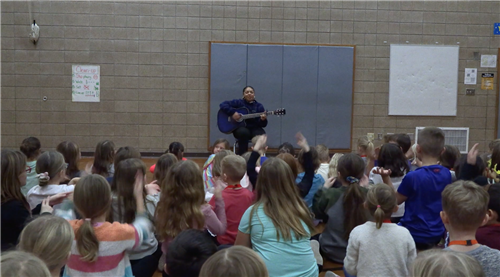 Imani singing with children at APlus